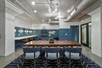 Conference room with wood table and blue paneled walls 1